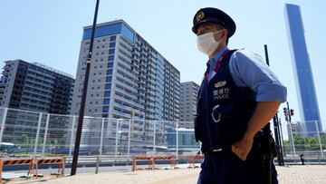 A police officer stands guard at the athletes' village for the Tokyo 2020 Olympic Games in Tokyo, Japan, July 22, 2021. REUTERS/Naoki Ogura