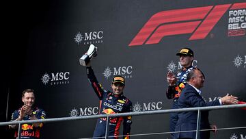 Second-placed Red Bull Racing's Mexican driver Sergio Perez celebrates with his trophy flanked by winner Red Bull Racing's Dutch driver Max Verstappen (R) on the podium  after the Formula One Belgian Grand Prix at the Spa-Francorchamps Circuit in Spa on July 30, 2023. (Photo by JOHN THYS / AFP)