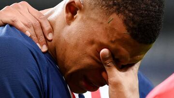 (FILES) In this file photo taken on July 24, 2020 Paris Saint-Germain's French forward Kylian Mbappe grimaces after an injury during the French Cup final football match between Paris Saint-Germain (PSG) and Saint-Etienne (ASSE)during the French Cup f