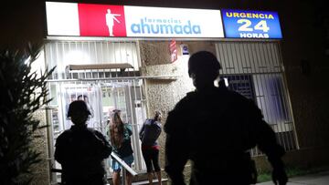 Soldiers guard a pharmacy in the city of Santiago after President Sebastian Pinera ordered a state of catastrophe, due to the outbreak of coronavirus disease (COVID-19) in Santiago, Chile, on March 20, 2020. REUTERS/Pablo Sanhueza