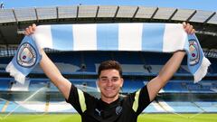 MANCHESTER, ENGLAND - JULY 10: Julian Alvarez of Manchester City poses with a Manchester City scarf inside the stadium during the Manchester City Summer Signing Presentation Event at Etihad Stadium on July 10, 2022 in Manchester, England. (Photo by Matt McNulty - Manchester City/Manchester City FC via Getty Images)