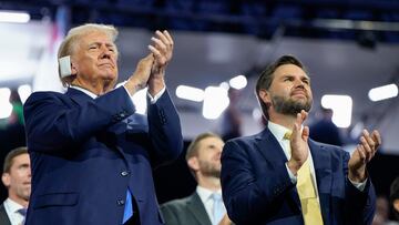Republican presidential nominee and former U.S. President Donald Trump and Republican vice presidential nominee J.D. Vance applaud on Day 2 of the Republican National Convention (RNC), at the Fiserv Forum in Milwaukee, Wisconsin, U.S., July 16, 2024. REUTERS/Elizabeth Frantz