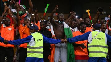 Members of the security staff contain the Ivory Coast&#039;s supporters celebrating the victory of their team at the end of the Group E Africa Cup of Nations (CAN) 2021 football match between Equatorial Guinea and Ivory Coast at Stade de Japoma in Douala 