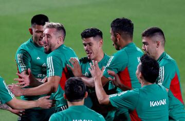 DOHA, QATAR - NOVEMBER 19:  Hector Herrera #16 of Team Mexico is congratulated by teammates during a training session for Team Mexico at Al Khor Stadium on November 19, 2022 in Doha, Qatar. (Photo by Elsa/Getty Images)