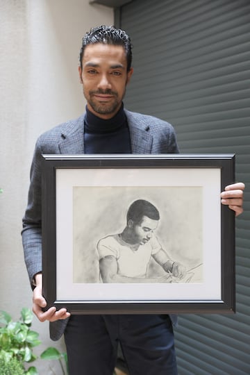 Sergio Cunningham posa con un retrato de su padre.