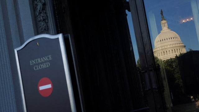 The U.S. Capitol dome is reflected in the Library of Congress glass door, with the sign reading "Entrance closed" in the foreground, on the first day of a partial government shutdown in Washington, D.C., U.S., October 1, 2025. REUTERS/Nathan Howard TPX IMAGES OF THE DAY