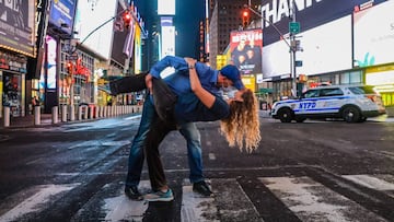 Couple of nurses kiss in Times Square wearing masks in New York during the Coronavirus COVID-19 pandemic in the United States. *** Local Caption *** .