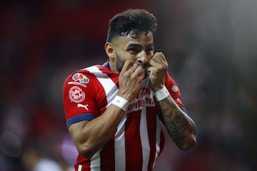 Alexis Vega kisses the Chivas shirt in a goal celebration.