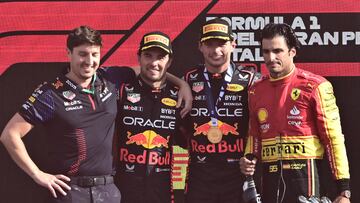 Second placed Red Bull Racing's Mexican driver Sergio Perez (2ndL), first placed Red Bull Racing's Dutch driver Max Verstappen and third placed Ferrari's Spanish driver Carlos Sainz Jr celebrate on the podium after the Italian Formula One Grand Prix race at Autodromo Nazionale Monza circuit, in Monza on September 3, 2023. (Photo by Marco BERTORELLO / AFP)