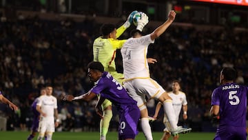 Mar 29, 2025; Carson, California, USA; Orlando City goalkeeper Pedro Gallese (1) makes a save against LA Galaxy defender Maya Yoshida (4) during the second half at Dignity Health Sports Park. Mandatory Credit: Kiyoshi Mio-Imagn Images