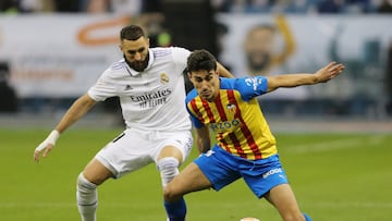 Soccer Football - Spanish Super Cup - Semi Final - Valencia v Real Madrid - King Fahd Stadium, Riyadh, Saudi Arabia - January 11, 2023 Valencia's Andre Almeida in action with Real Madrid's Karim Benzema REUTERS/Ahmed Yosri