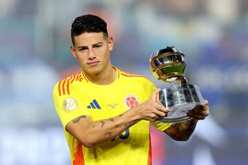 Colombia's midfielder #10 James Rodriguez poses with the trophy for best player of the tournament at the end of the Conmebol 2024 Copa America tournament final football match between Argentina and Colombia at the Hard Rock Stadium, in Miami, Florida on July 14, 2024. (Photo by CHARLY TRIBALLEAU / AFP)