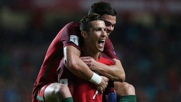 Portugal&#039;s forward Cristiano Ronaldo celebrates with teammate Portugal&#039;s defender Pepe after scoring a goalduring the FIFA 2018 World Cup Qualifier match