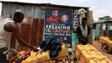 Men stand near carts loaded with water containers for sale, amid concerns over the spread of the coronavirus disease (COVID-19) in Abuja, Nigeria June 25, 2020. REUTERS/Afolabi Sotunde