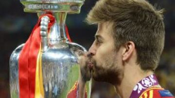 El internacional español Gerard Piqué besa la copa durante la final de la Eurocopa de fútbol 2012 entre España e Italia en el estadio Olímpico de Kiev, Ucrania hoy, domingo 1 de julio de 2012. España ganó el encuentro por 4-0.