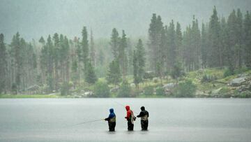 ESTES PARK, CO - AUGUST 16: Kit Jordan, a fly fishing guide with Sawatch Fly Fishing Guides, center, helps members of the Haiflich family learn how to fly fish at Sprague Lake in Rocky Mountain National Park on August 16, 2022 near Estes Park, Colorado. Despite the heavy downpours that took place in the Park the family, which came from Indiana for vacation, had a great time fishing for Brook and Brown trout. (Photo by Helen H. Richardson/MediaNews Group/The Denver Post via Getty Images)