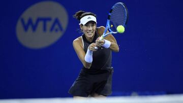 Maria Garbine Muguruza of Spain hits a return against Jelena Ostapenko of Latvia during their women's singles quarter-final match at the WTA Wuhan Open tennis tournament in Wuhan, in China's central Hubei province on September 29, 2017. / AFP PHOTO / WANG ZHAO