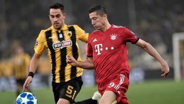 AEK&#039;s Greek defender Vassilis Lampropoulos (L) vies with Bayern Munich&#039;s Polish forward Robert Lewandowski during the UEFA Champions League football match between AEK Athens FC and FC Bayern Munchen at the OACA Spyros Louis stadium in Athens on 