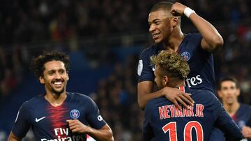 Paris Saint-Germain's French forward Kylian Mbappe (C) celebrates with Paris Saint-Germain's Brazilian forward Neymar (R) and Paris Saint-Germain's Brazilian defender Marquinhos after he scored a goal during the French L1 football match bet