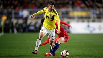 James rodr&iacute;guez pelea un bal&oacute;n en ante Lee Jae-sung en el juego ante Corea del Sur.