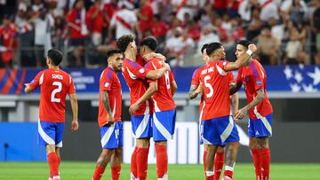 Chile's defender #16 Igor Lichnovsky (3rd L) greets Chile's midfielder #08 Dario Osorio at the end of the Conmebol 2024 Copa America