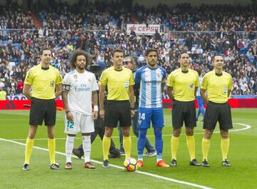 Captains Marcelo and Recio pose for a pre-match photo with the match officials.