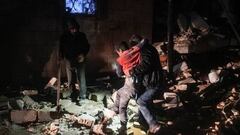 A man carries away an injured child following an earthquake in the town of Jandaris, in the countryside of Syria's northwestern city of Afrin in the rebel-held part of Aleppo province, early on February 6, 2023. - At least eight people have been killed in north Syria after a 7.8-magnitude earthquake that originated in Turkey and was felt across neighbouring countries. (Photo by Rami al SAYED / AFP) (Photo by RAMI AL SAYED/AFP via Getty Images)