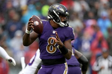 BALTIMORE, MARYLAND - OCTOBER 02: Quarterback Lamar Jackson #8 of the Baltimore Ravens fakes a handoff against the Buffalo Bills at M&T Bank Stadium on October 02, 2022 in Baltimore, Maryland.   Rob Carr/Getty Images/AFP