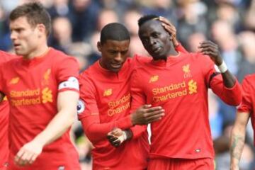 Liverpool's Senegalese midfielder Sadio Mane (R) celebrates with Liverpool's Dutch midfielder Georginio Wijnaldum after scoring the opening goal of the English Premier League football match between Liverpool and Everton at Anfield in Liverpool, north west