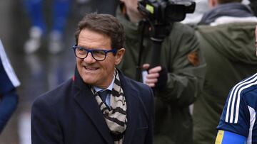 Former Italian football player Fabio Capello (L) and newly-elected FIFA president Gianni Infantino (R) holding a ball, arrive on February 29, 2016 at the FIFA headquarters in Zurich.