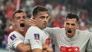 Switzerland's midfielder #23 Xherdan Shaqiri (C) celebrates with teammates after scoring his team's first goal during the Qatar 2022 World Cup Group G football match between Serbia and Switzerland at Stadium 974 in Doha on December 2, 2022. (Photo by Ina Fassbender / AFP)