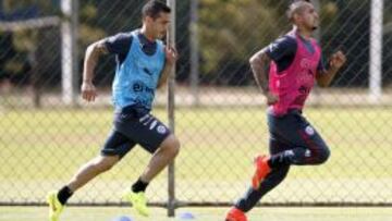 Carmona, detr&aacute;s de Arturo Vidal durante un entrenamiento de Chile en Brasil.