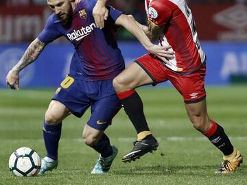 Leo Messi tussles with Pablo Maffeo.