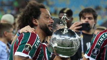 Fluminense's defender Marcelo celebrates with the trophy after winning the Copa Libertadores final football match between Brazil's Fluminense and Argentina's Boca Juniors at Maracana Stadium in Rio de Janeiro, Brazil, on November 4, 2023. (Photo by Pablo PORCIUNCULA / AFP)