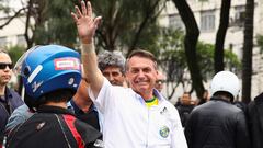 Brazil's President and candidate for re-election Jair Bolsonaro greets supporters as he attends to take part in a motorcade in Sao Paulo, Brazil October 1, 2022. REUTERS/Carla Carniel