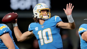 INGLEWOOD, CALIFORNIA - JANUARY 02: Justin Herbert #10 of the Los Angeles Chargers delivers a pass over the defense of the Denver Broncos in the first quarter of the game at SoFi Stadium on January 02, 2022 in Inglewood, California.   Sean M. Haffey/Getty