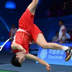 China�s Li Shifeng does a flip as he celebrates his victory against compatriot Shi Yuqi in their men�s badminton singles final match during the Hangzhou 2022 Asian Games in Hangzhou, in China�s Zhejiang province on October 7, 2023. (Photo by ADEK BERRY / AFP)