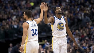 Curry y Durant se saludan durante un partido