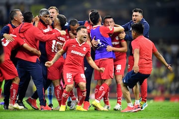 Toluca's players celebrate after defeating America during their Mexican Apertura football tournament semifinal match at the Azteca Stadium 