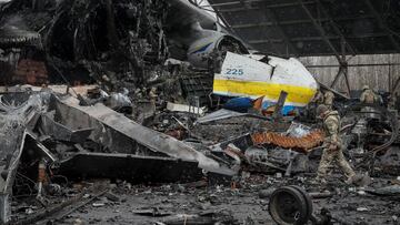 A Ukrainian service member walks in a front of an Antonov An-225 Mriya cargo plane, the world&#039;s biggest aircraft, destroyed by Russian troops as Russia&#039;s attack on Ukraine continues, at an airfield in the settlement of Hostomel, in Kyiv region, 