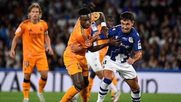 Real Madrid's Brazilian forward #07 Vinicius Junior and Real Sociedad's Spanish midfielder #04 Martin Zubimendi (R) vie for the ball during the Spanish league football match between Real Sociedad and Real Madrid CF at the Anoeta stadium in San Sebastian on September 14, 2024. (Photo by ANDER GILLENEA / AFP)
