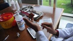 A doctor  prepares a dose to inoculate a beneficiary against Covid-19 at  Charles Nicole Hospital in Tunis,Tunisia on July 17,2022. (Photo by Yassine Mahjoub/NurPhoto via Getty Images)