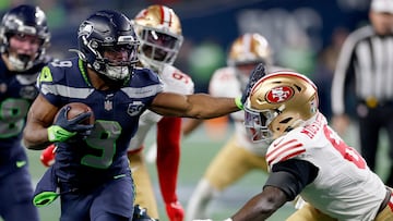 SEATTLE, WASHINGTON - JANUARY 17: Kenneth Walker III #9 of the Seattle Seahawks stiff arms Malik Mustapha #6 of the San Francisco 49ers during the third quarter in the NFC Divisional Playoff game at Lumen Field on January 17, 2026 in Seattle, Washington. Harry How/Getty Images/AFP (Photo by Harry How / GETTY IMAGES NORTH AMERICA / Getty Images via AFP)