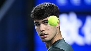 Spain�s Carlos Alcaraz looks at a ball during the men's singles match agaisnt Bulgaria�s Grigor Dimitrov at the Shanghai Masters tennis tournament on October 11, 2023. (Photo by WANG Zhao / AFP)