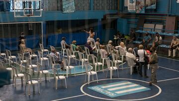 BUENOS AIRES, ARGENTINA - FEBRUARY 22: Citizens over eighty years old sit on the basketball court of Racing Club headquarters after receiving the first dose of Covishield (Oxford-AstraZeneca) vaccine during the launch day of the second stage of the national vaccination plan on February 22, 2021 in Buenos Aires, Argentina. From today, citizens over 80 years old and residents of nursing homes can be vaccinated against COVID-19. (Photo by Ricardo Ceppi/Getty Images)