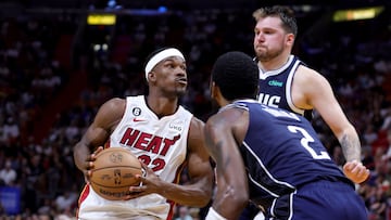 MIAMI, FLORIDA - APRIL 01: Jimmy Butler #22 of the Miami Heat drives against Kyrie Irving #2 and Luka Doncic #77 of the Dallas Mavericks during the fourth quarter of the game at Miami-Dade Arena on April 01, 2023 in Miami, Florida. NOTE TO USER: User expressly acknowledges and agrees that, by downloading and or using this photograph, User is consenting to the terms and conditions of the Getty Images License Agreement. Megan Briggs/Getty Images/AFP (Photo by Megan Briggs / GETTY IMAGES NORTH AMERICA / Getty Images via AFP)
