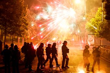 French police stand in position as fireworks go off during clashes with youth, after the death of Nahel, a 17-year-old teenager killed by a French police officer during a traffic stop, in Nanterre, Paris suburb, France, June 30, 2023. REUTERS/Gonzalo Fuentes     TPX IMAGES OF THE DAY