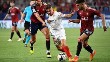 Iván Romero trata de escapar de dos jugadores de Osasuna en el estreno de temporada. AFP