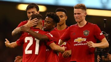 Manchester United&#039;s Daniel James (L) celebrates with teammates after he scores the winning penalty during the 2019 International Champions Cup football match between Manchester United and A C Milan at the Principality Stadium, Cardiff on August 3, 20