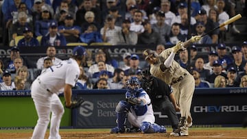 LOS ANGELES, CALIFORNIA - OCTOBER 12: Manny Machado #13 of the San Diego Padres hits a RBI double during the third inning in game two of the National League Division Series against the Los Angeles Dodgers at Dodger Stadium on October 12, 2022 in Los Angeles, California.   Kevork Djansezian/Getty Images/AFP